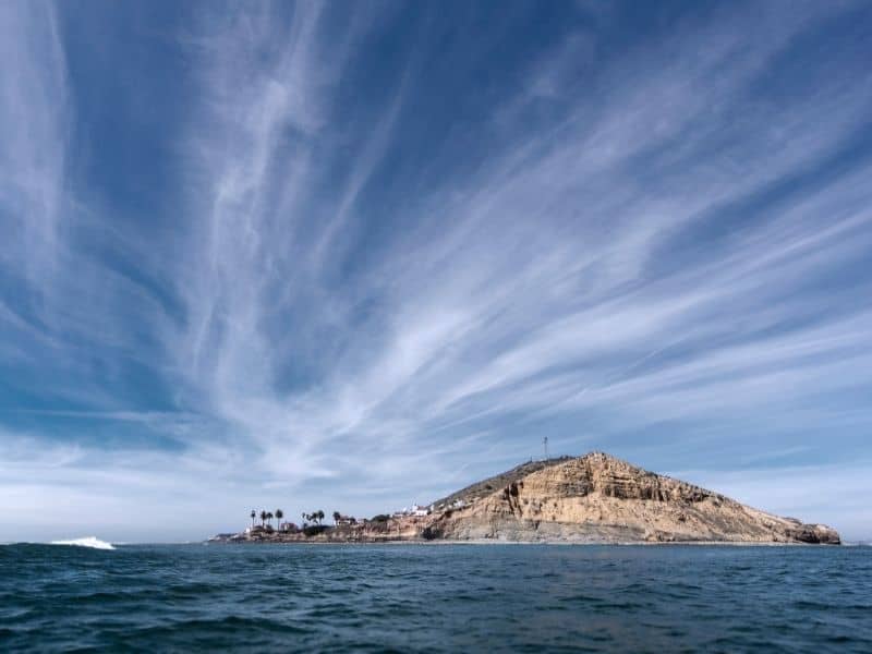 looking at the point loma lighthouse from afar out on the water