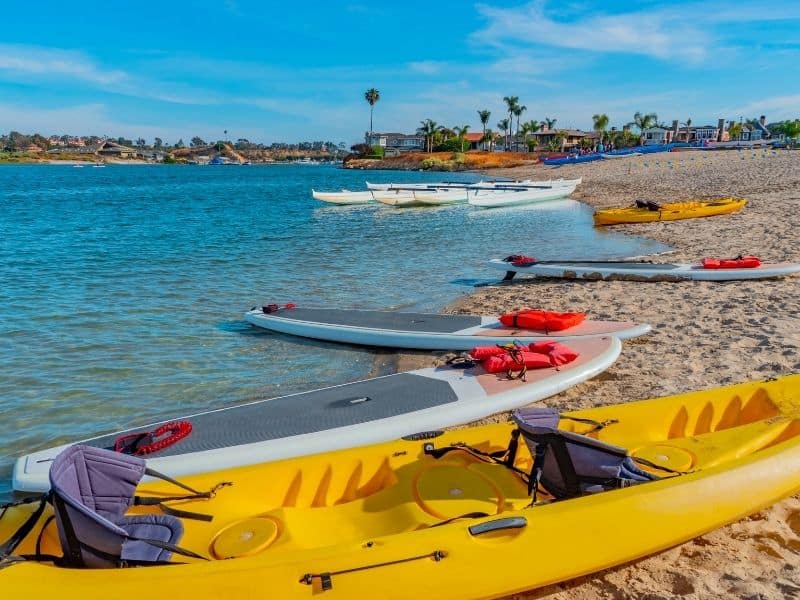 kayaks and paddleboards in newport beach in a variety of colors