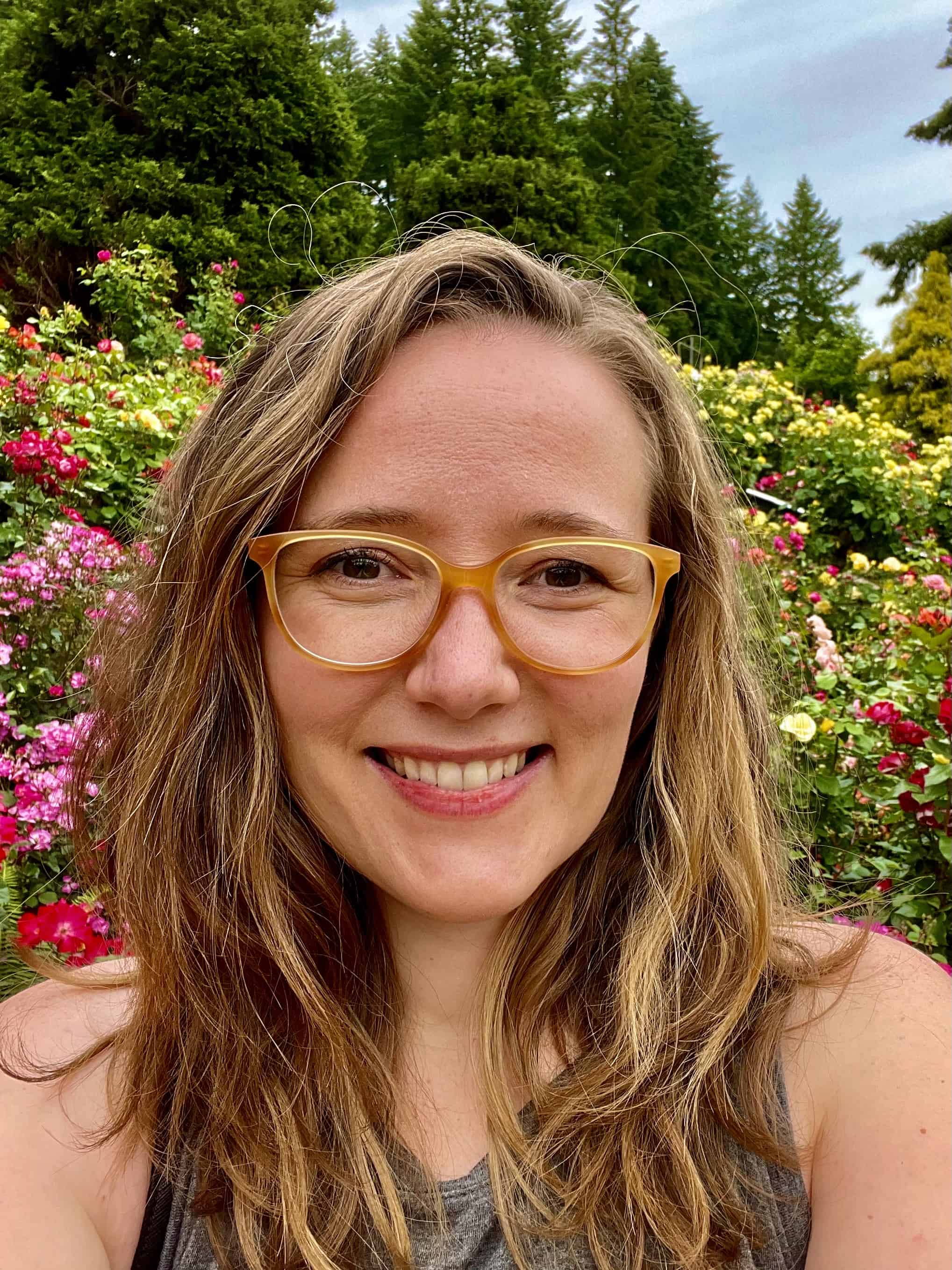 author hilary blum in front of flowers