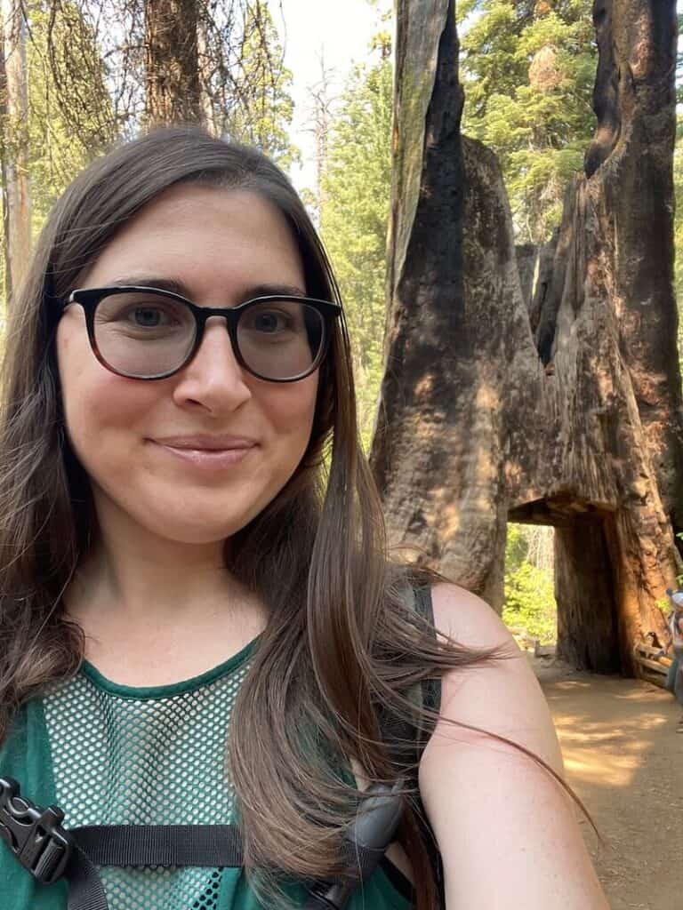 allison with the tuolumne tree tunnel behind her