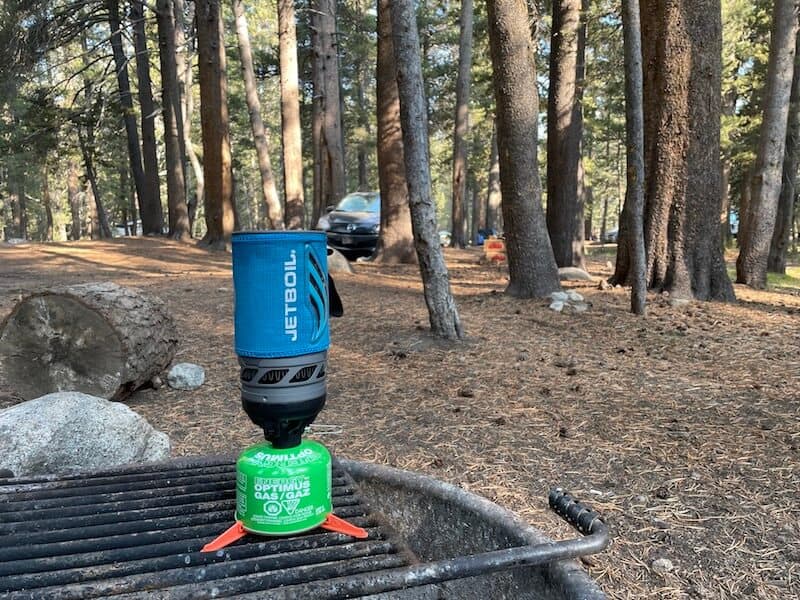 blue jetboil on a fire pit