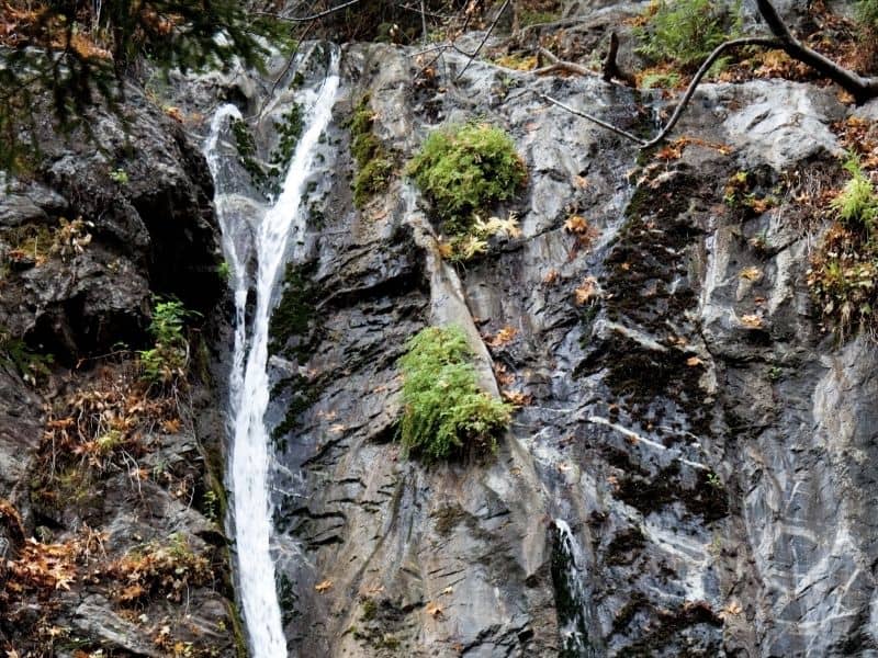 waterfall cascading over the rock edge of a cliff