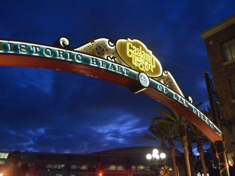 the archway entrance to the gaslamp quarter lit up at night with lights