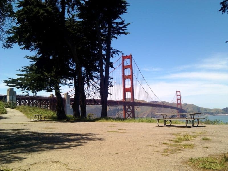 picnic table in front of the golden gate bridge with beautiful views of the water