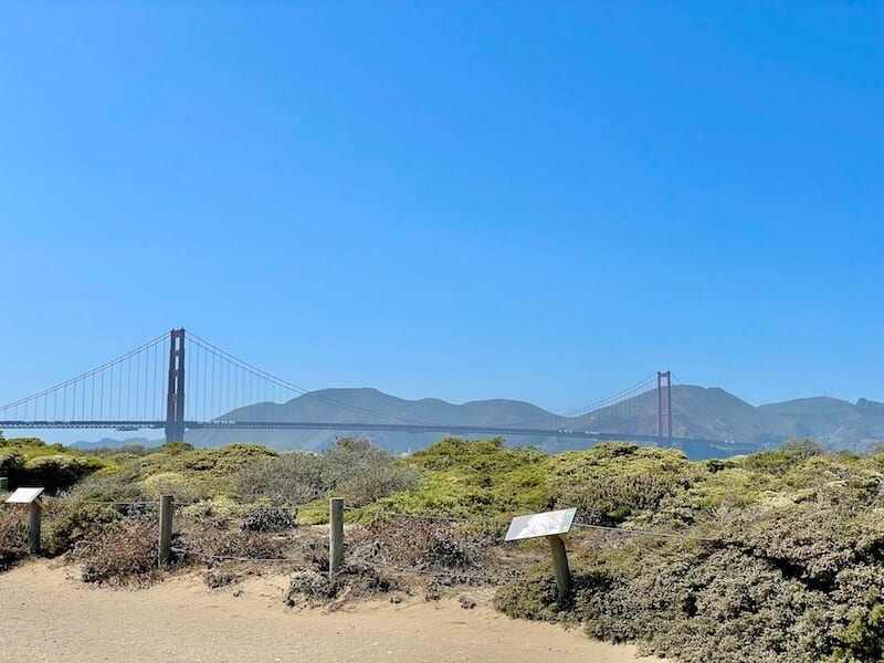 The Golden Gate Bridge on a blissfully sunny day near Crissy Field with trail and views