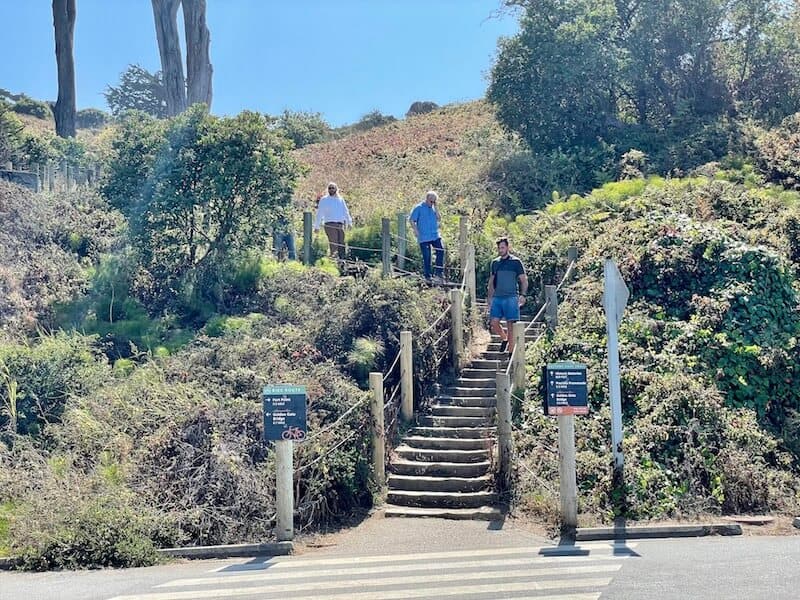 people walking up the stairs to begin the short battery east trail wich will take you up to the starting point for the golden gate bridge walk