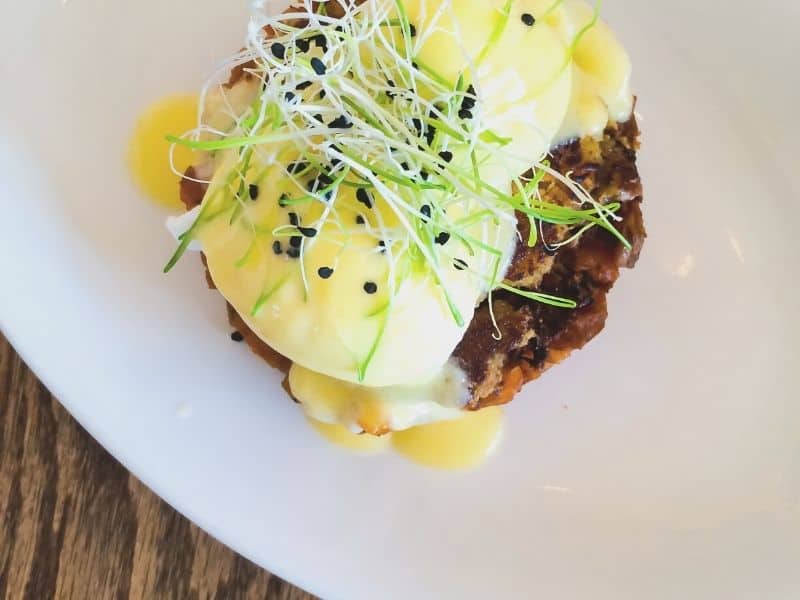 fancy crab cake benedict on a plate seen from above