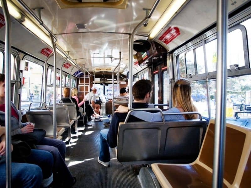 taking public transit in san francisco inside of a bus with people inside