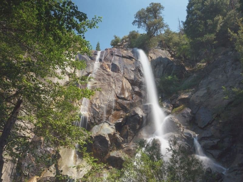 waterfall cascading over rocks from a cliff in kings canyon national park