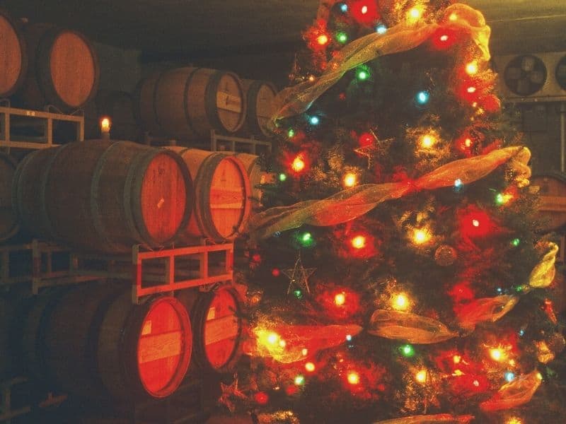 wine barrels and a christmas tree lit up and decorated