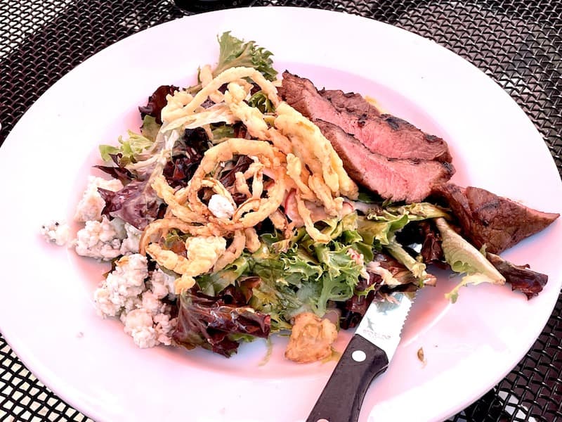 a steak, blue cheese, and fried onion salad in point reyes