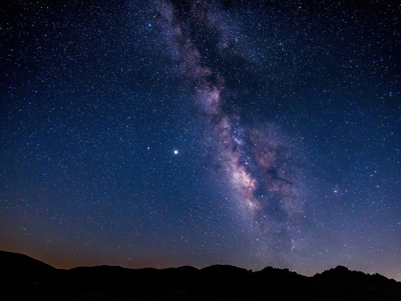 brilliant magenta and purple hues of the milky way over a desert landscape in anza borrego a dark sky park in california