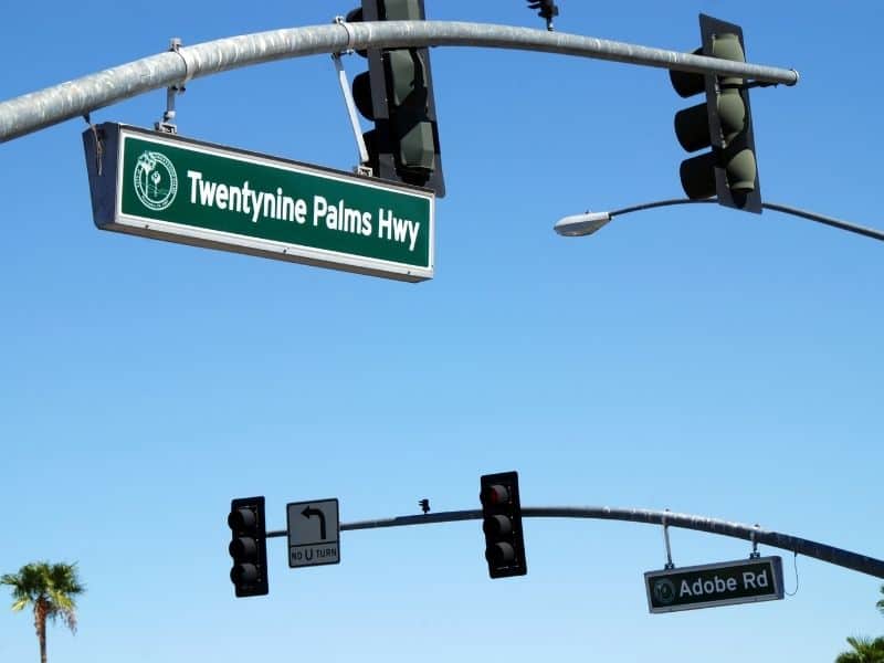 sign for twentynine palms highway over a streetlight