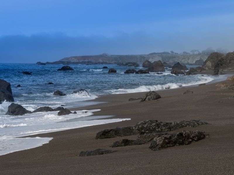 dark sandy beach at portuguese beach in california