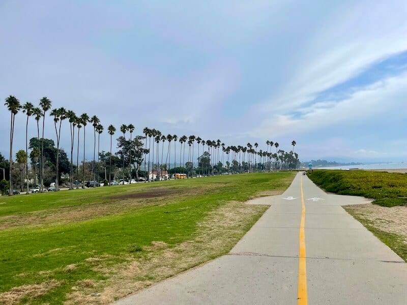 santa barbara coastal trail with two lanes and a sunny sky and palm trees 