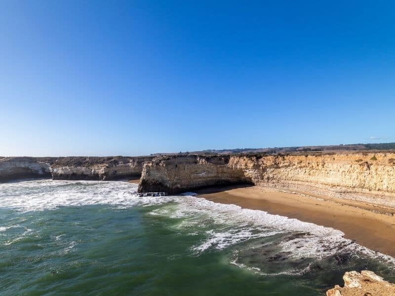 rocky cliffs and sandy beach at wilder beach in wilder ranch state park