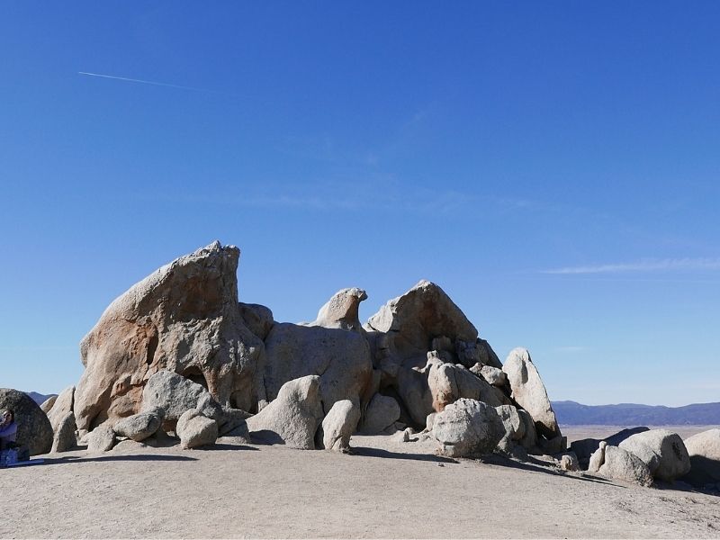 Rock formation in the shape of an eagle with mountains visible in the distance