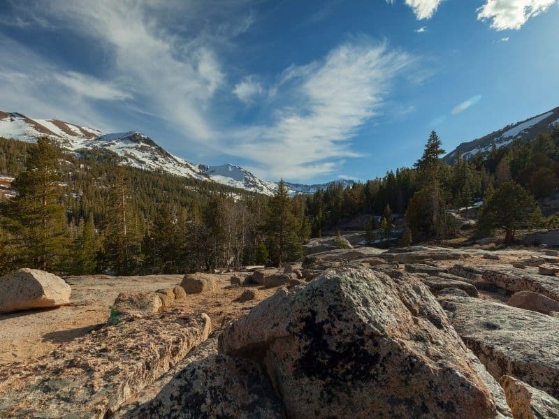 rocks along the trail at Sonora pass with mountains in the high sierras visible in the distance