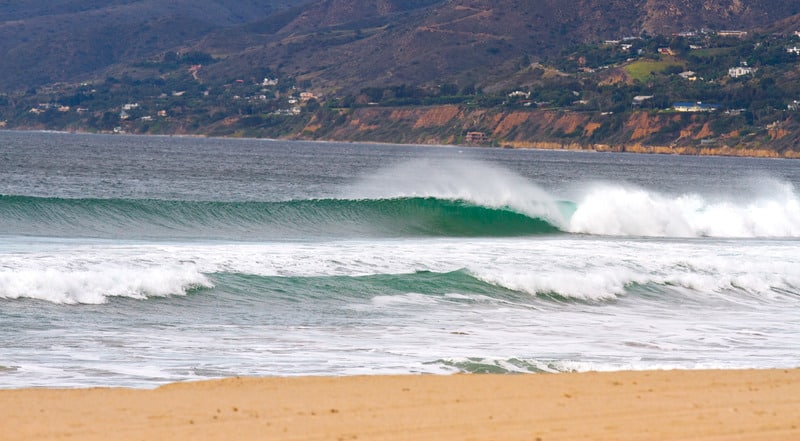 A wave peels to the shore at Zuma Beach California.