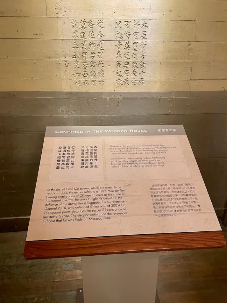 Chinese poem carved into wall of a detention center at Angel Island with translated text and explanation of poem