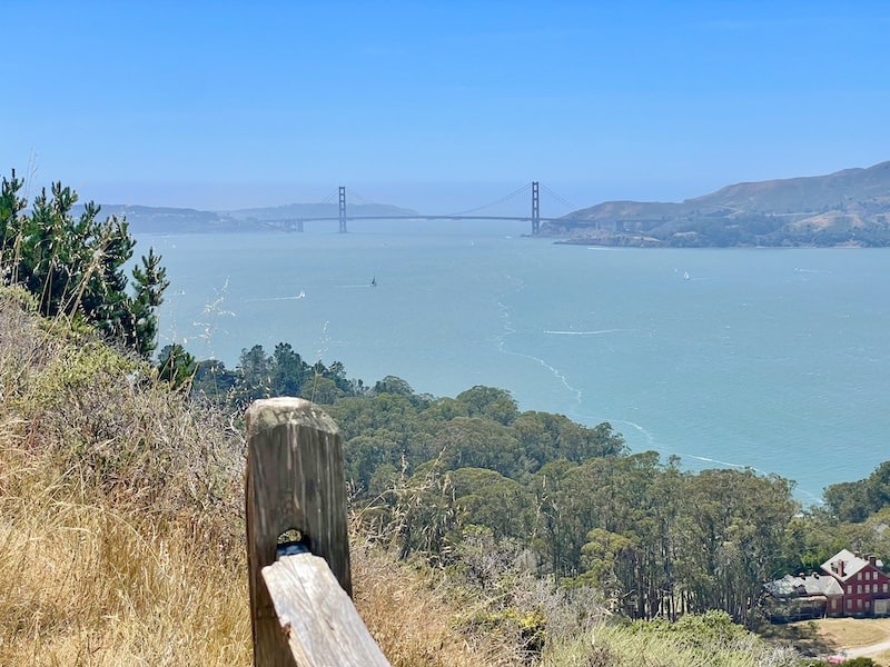 The Golden Gate Bridge visible in the distance from a hiking trail on Angel Island on a clear day